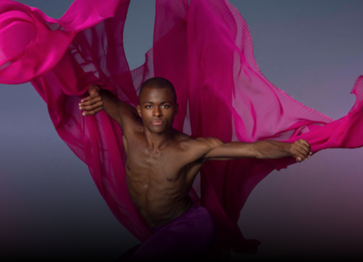 Photo of an Ailey dancer using expressive vibrant maroon silks