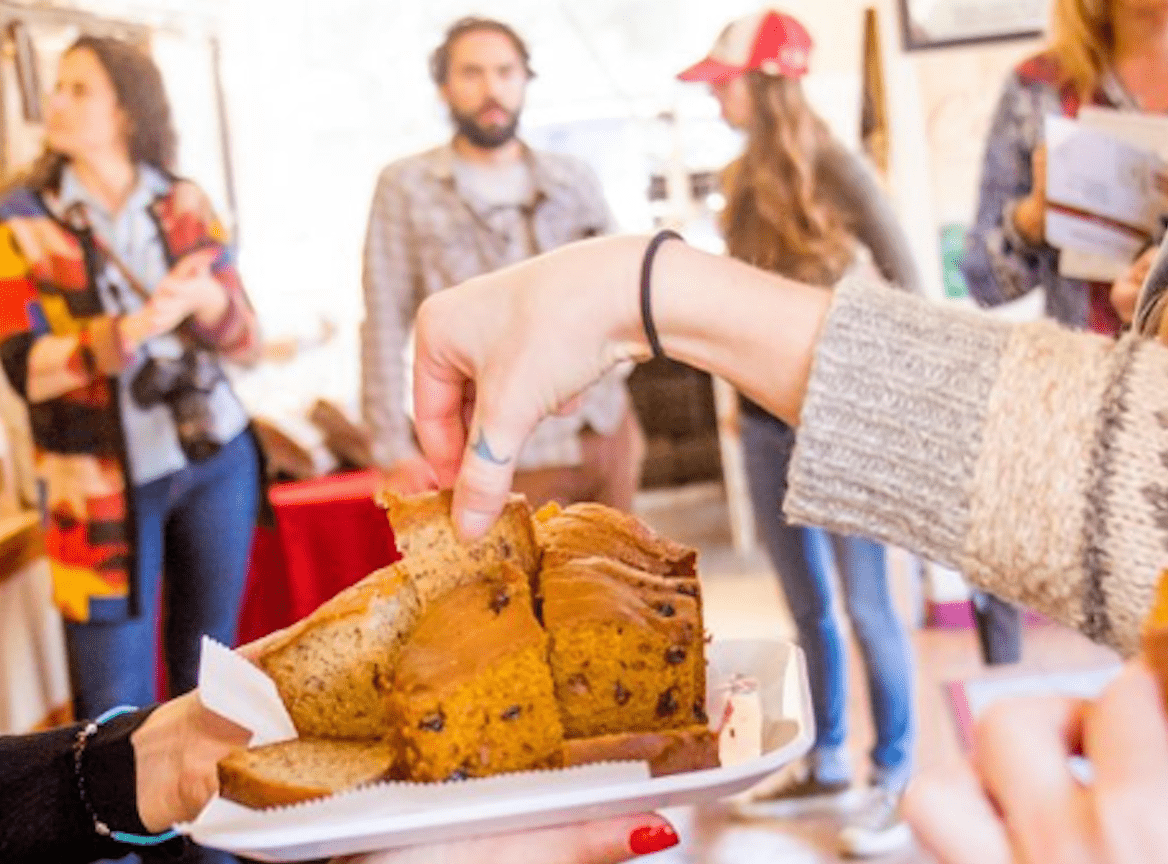 Attendee of Taste of SLO tries some freshly baked carrot/raisin bread