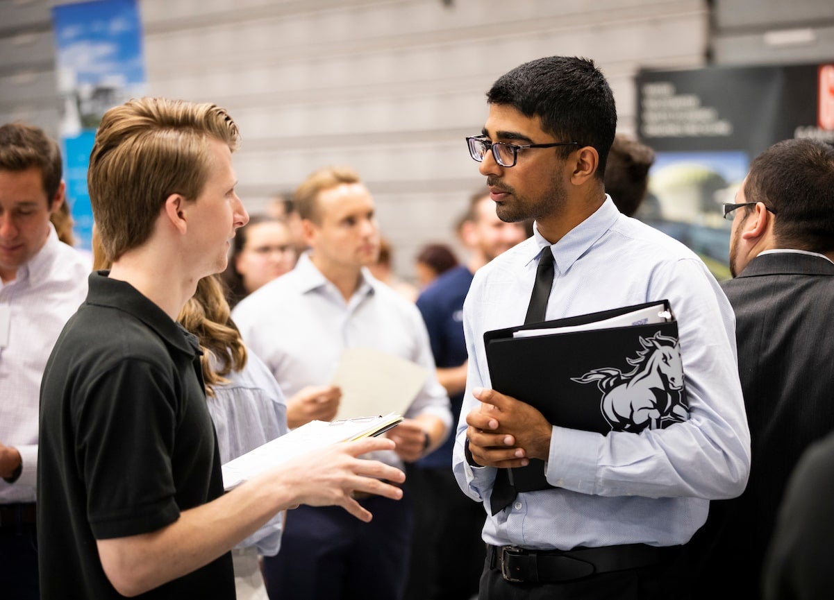 Cal Poly student meets with potential employer at the CAFES Connection Networking Event