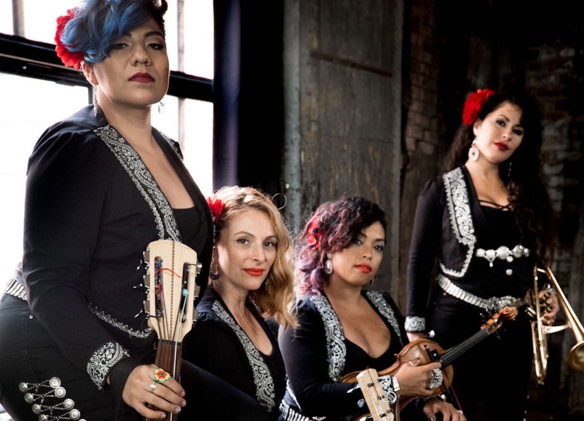 Members of FLOR DE TOLOACHE pose for a press shot in concert dress