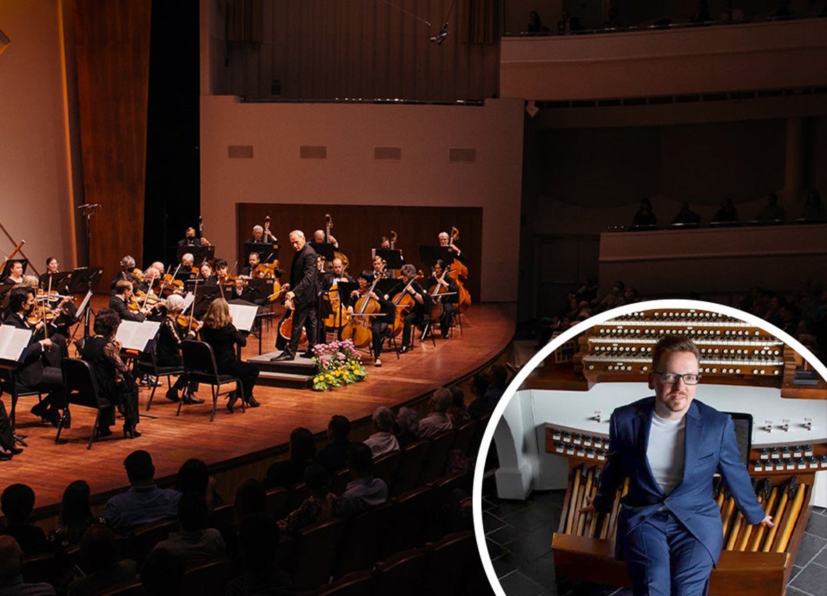 Symphony on stage playing, Felix Hell, organist featured in foreground.