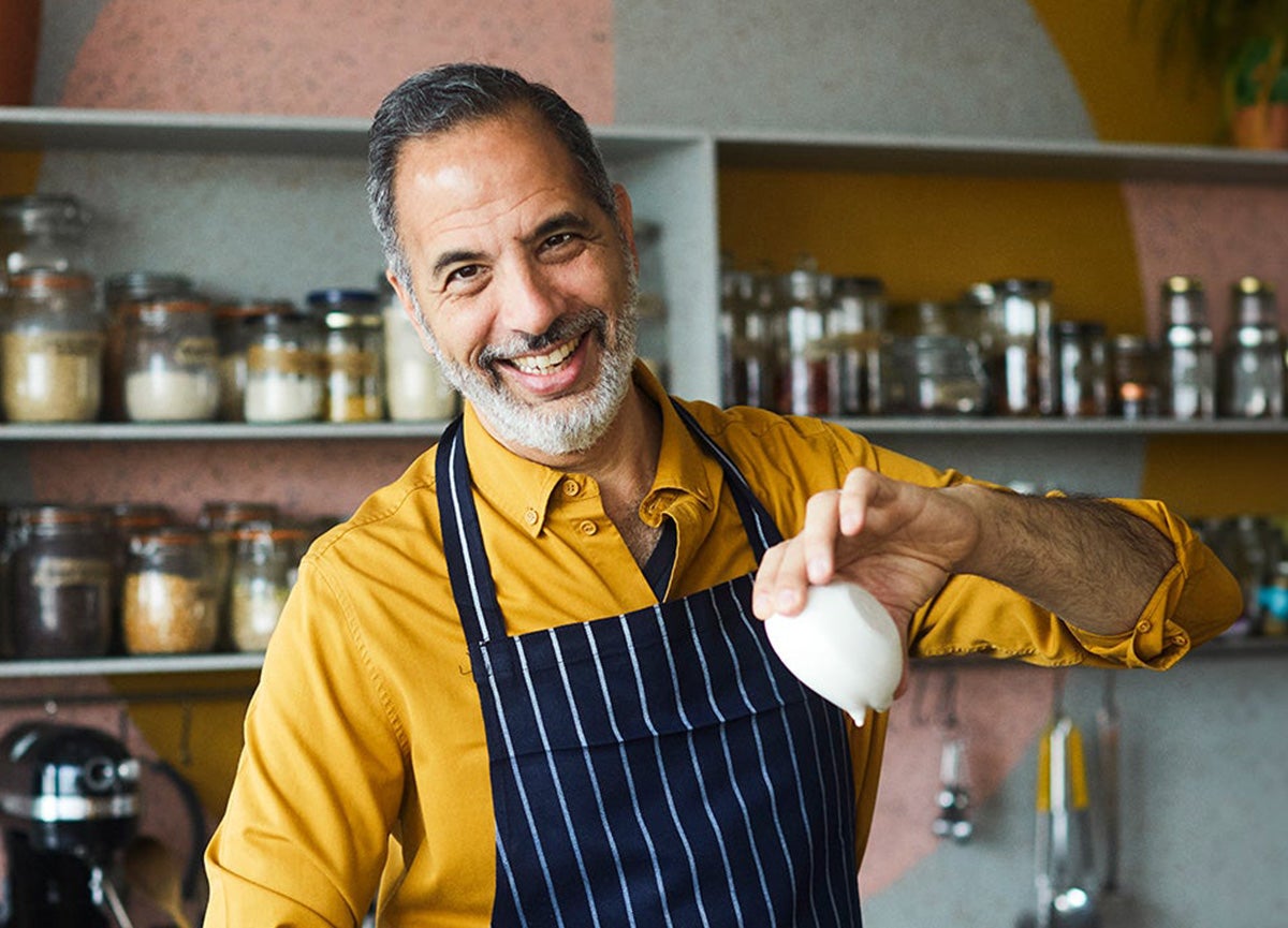 Yotam in kitchen with bowl in hand.