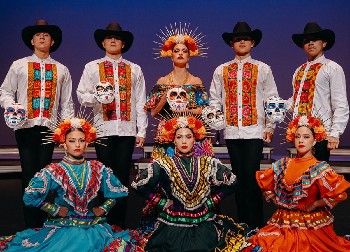 Group dressed in dia de los muertos outfits.