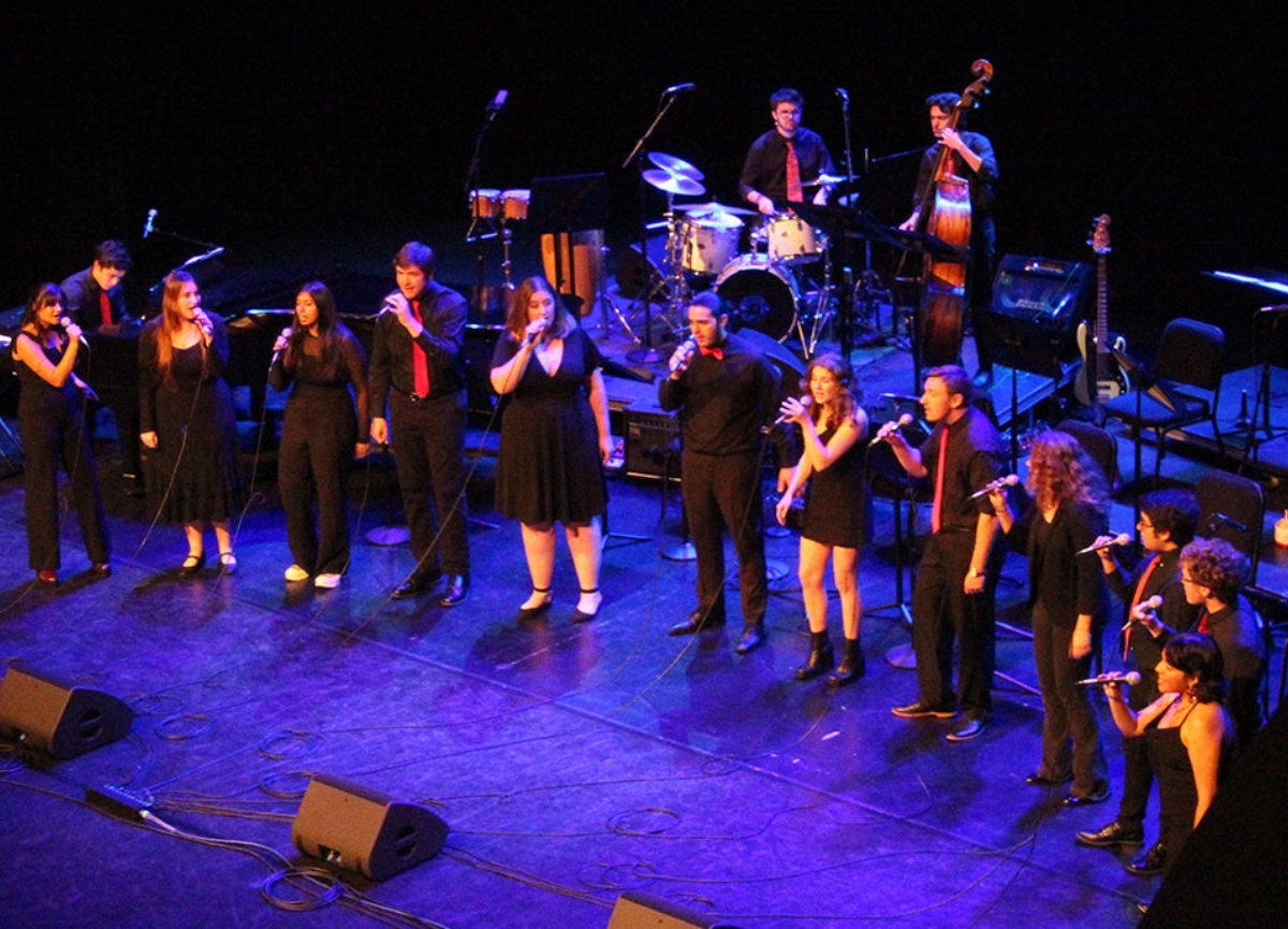 Singers on stage perform.