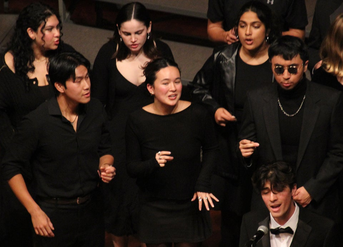 Choral students sing on stage.