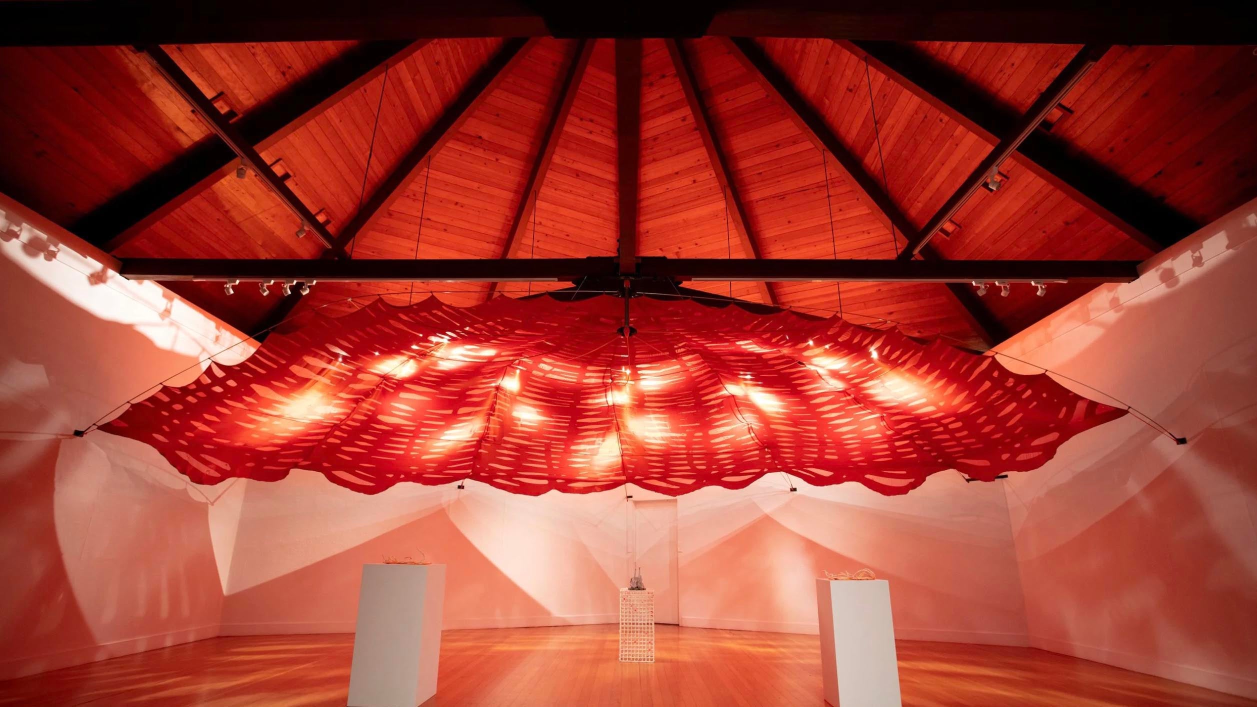 A large-scale sculptural installation by artist Kerri Conlon showing a fabric canopy hanging from the ceiling.