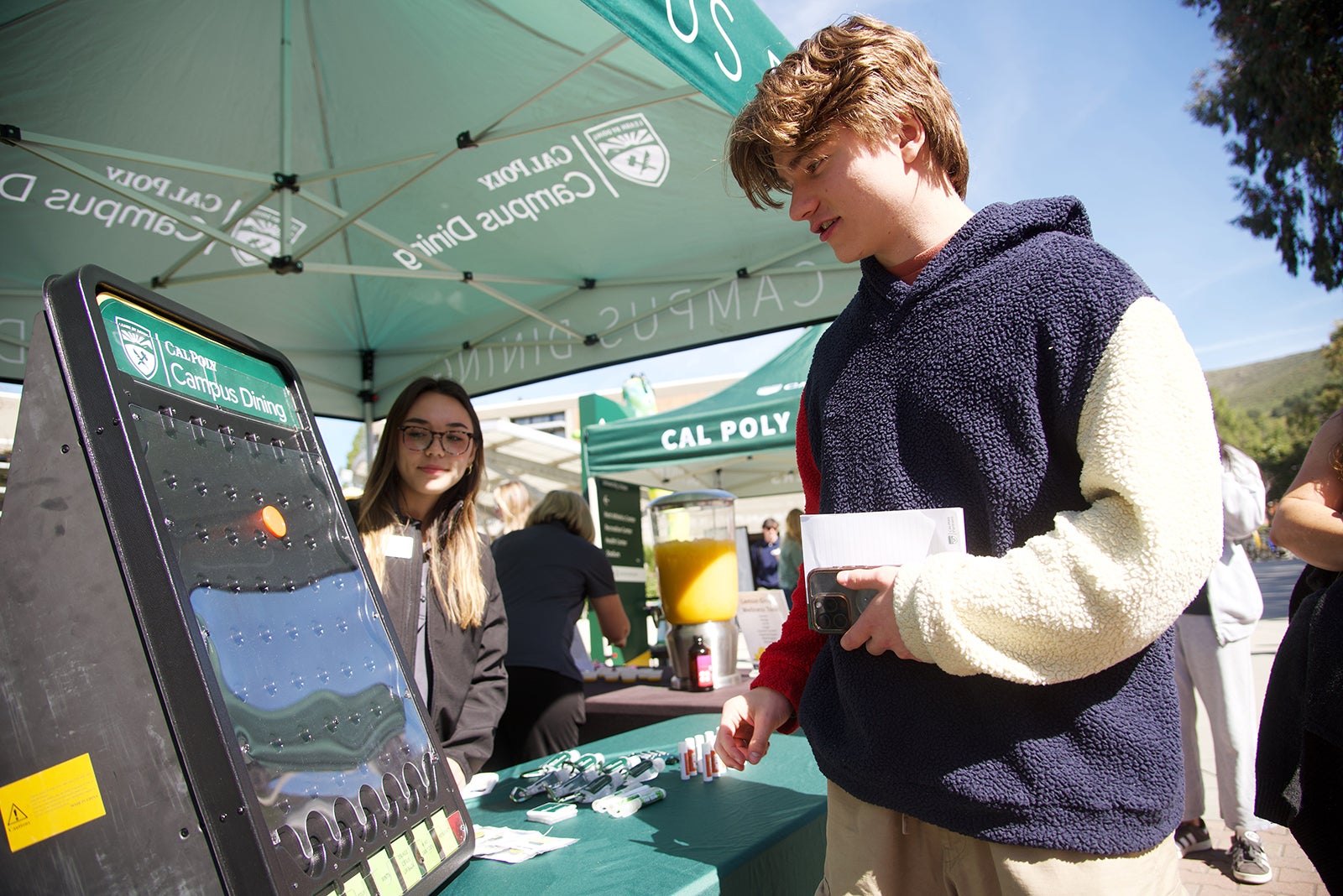 A student playing a game at a Cal Poly Partners event.