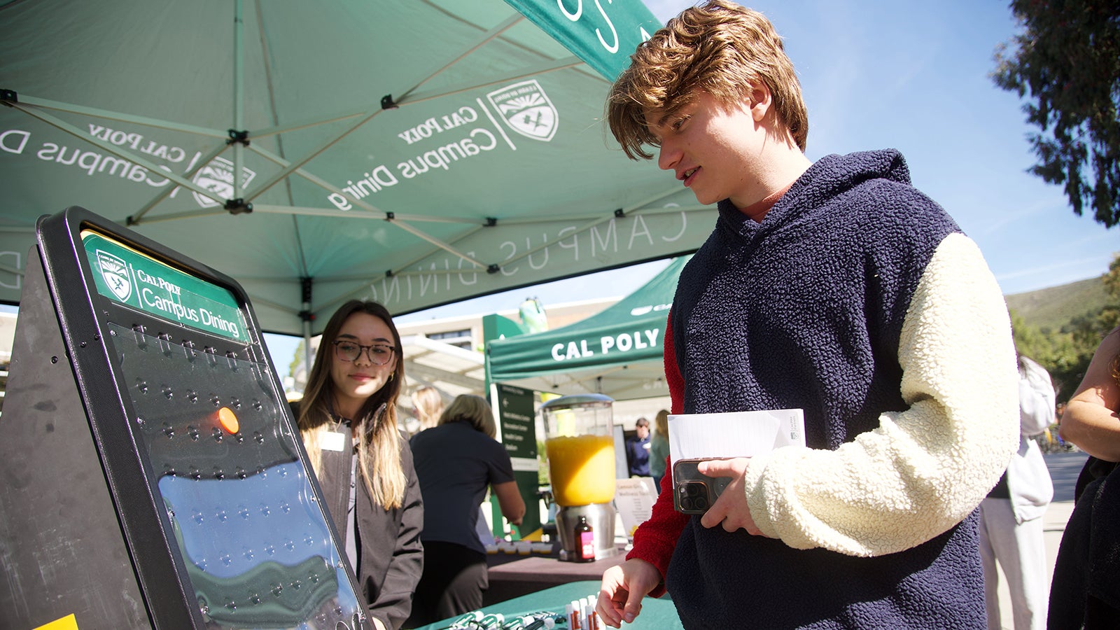 A student playing a game at a Cal Poly Partners event.