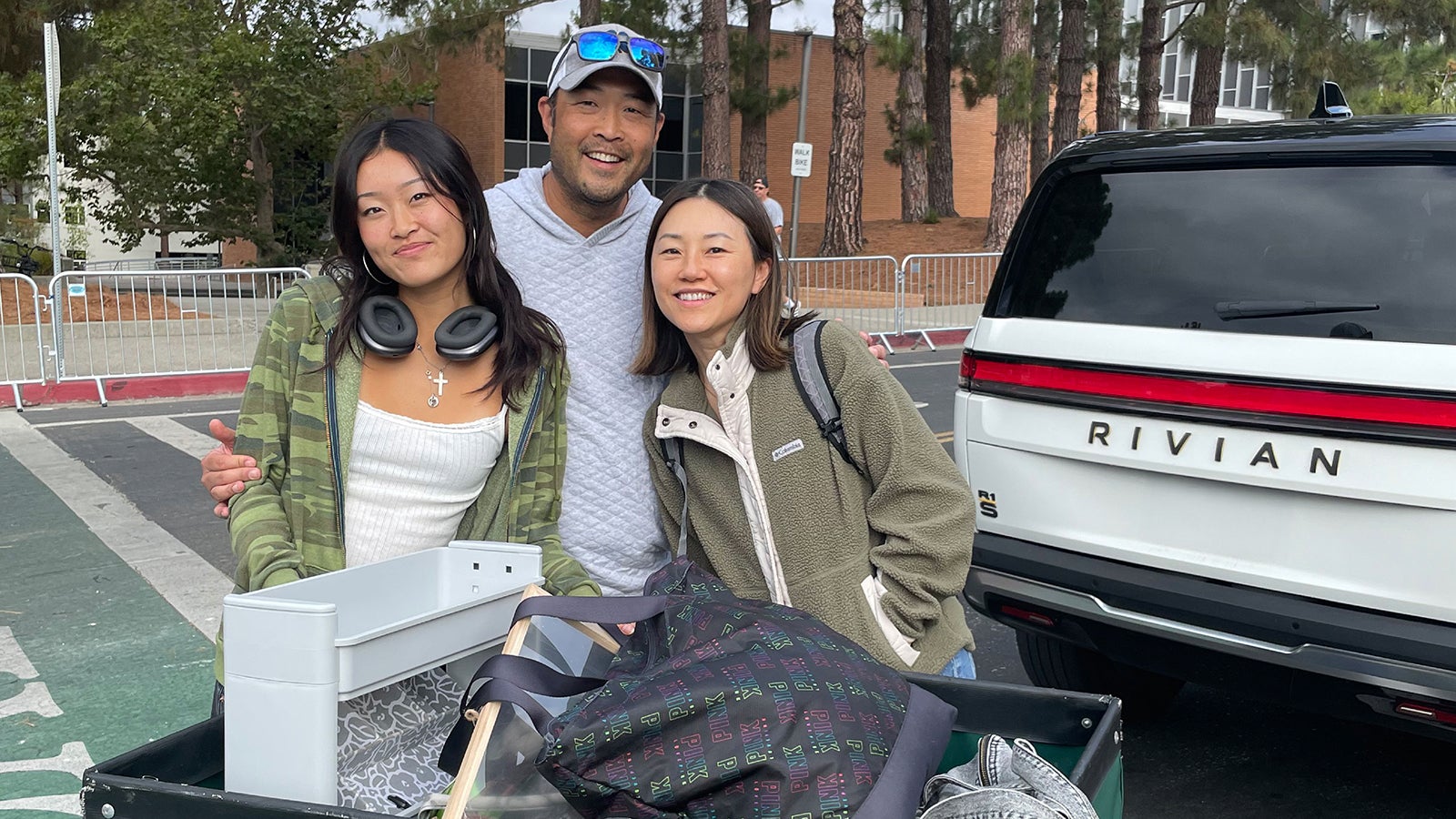 A family helping their student move into the dorms on Cal Poly's campus.