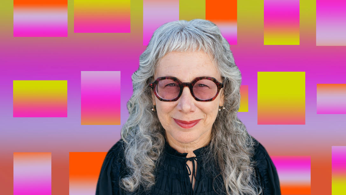A headshot of Louise Sandhaus with a colorful, geometric background.