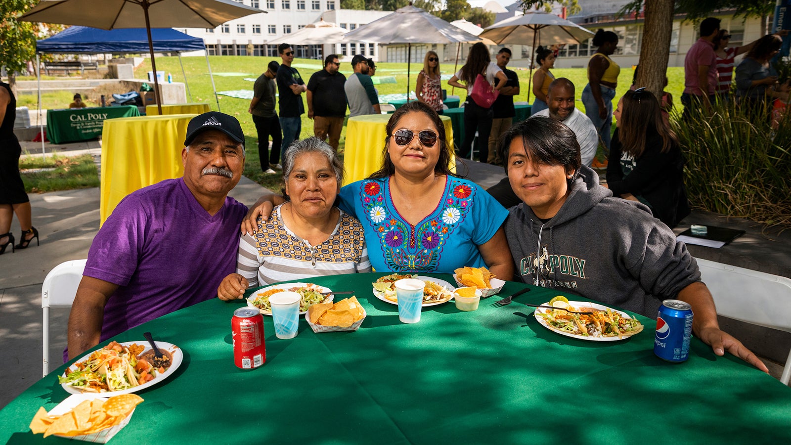A family attending a Mustang Family Weekend picnic.