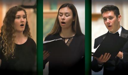 Three choir members in concert black sing from music folders