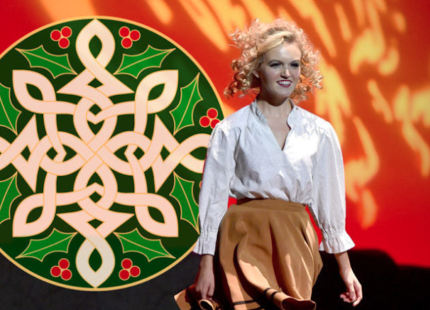 Cast member of "An Irish Christmas" walks out on stage. 