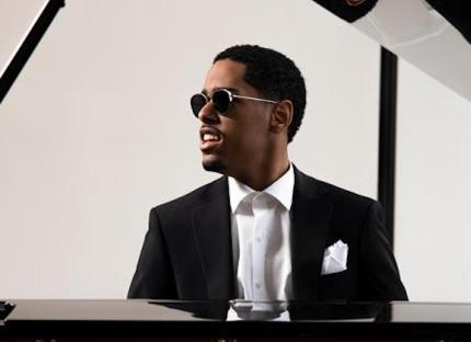 Pianist Matthew Whitaker sitting at his piano.