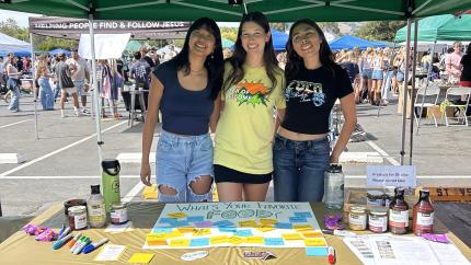Food Science Club members posing together in their booth at a club event.