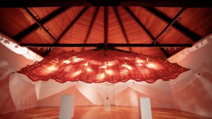 A large-scale sculptural installation by artist Kerri Conlon showing a fabric canopy hanging from the ceiling.