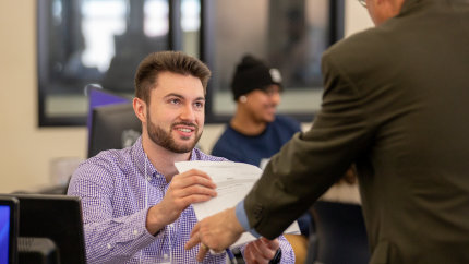 A volunteer with the Cal Poly tax clinic helps a client.