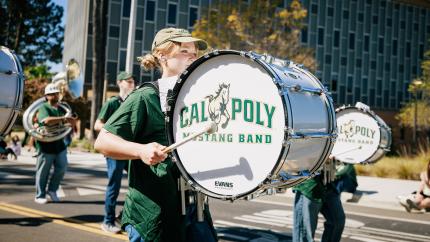 Students playing drums and other instruments during the Open House parade.