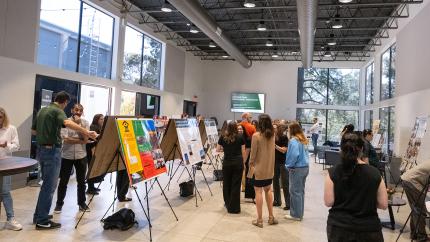 People talking and engaging with informational displays.