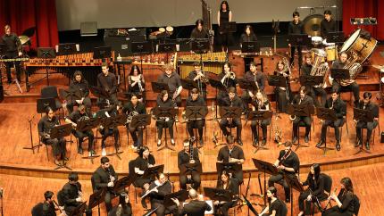 Cal Poly Wind Bands performing on stage.