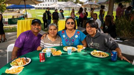 A family attending a Mustang Family Weekend picnic.