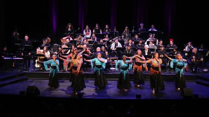 The Arab Music Ensemble and dancers performing on stage.