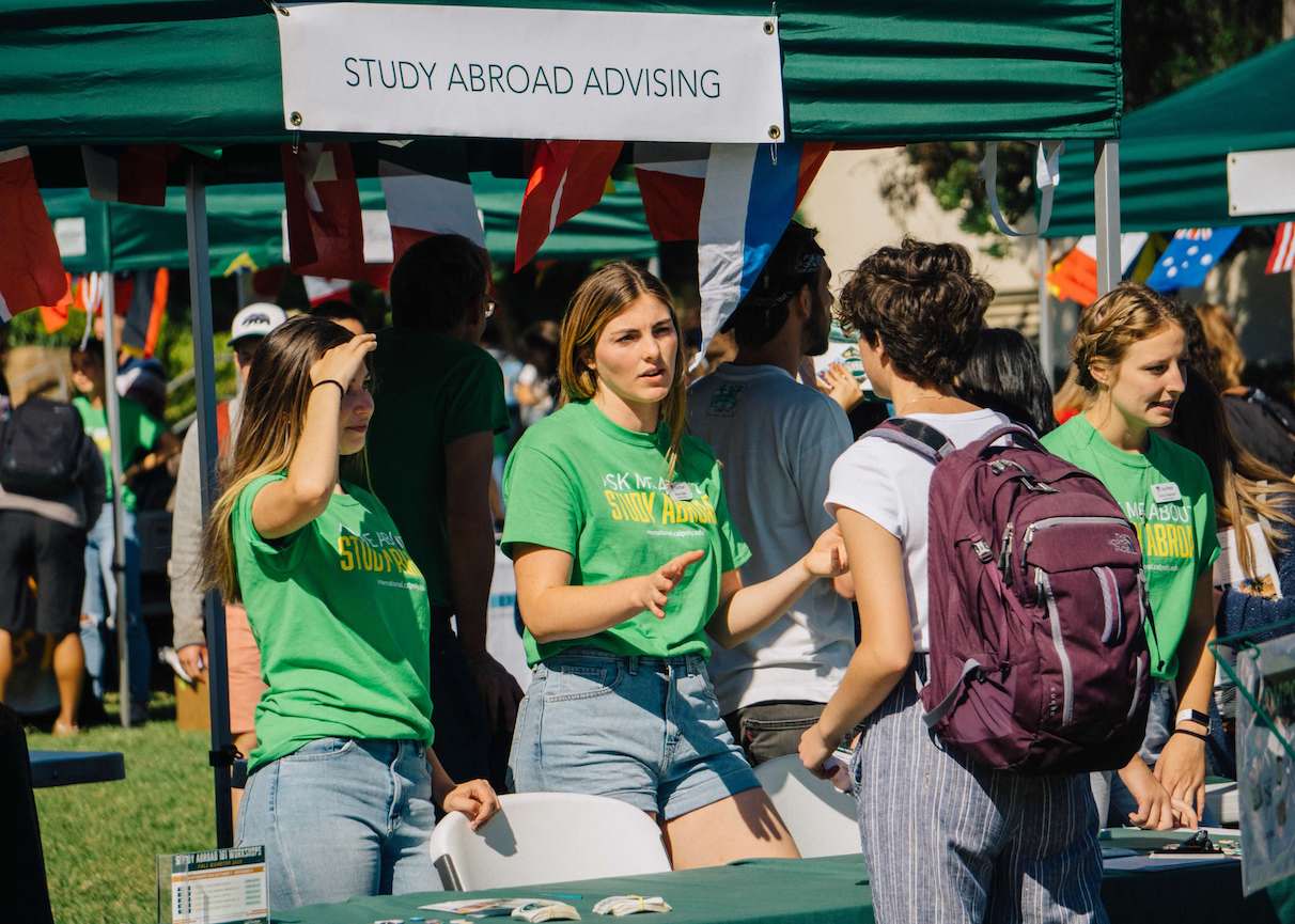 Study Abroad students interact with interested students at fair