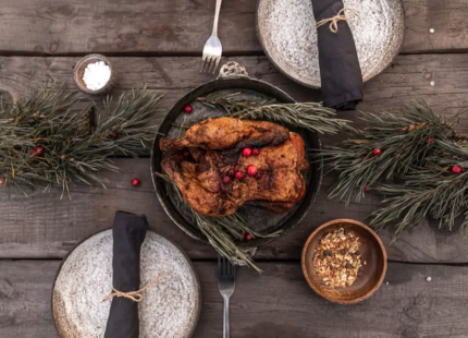 A turkey, plates and decorations adorn a rustic table
