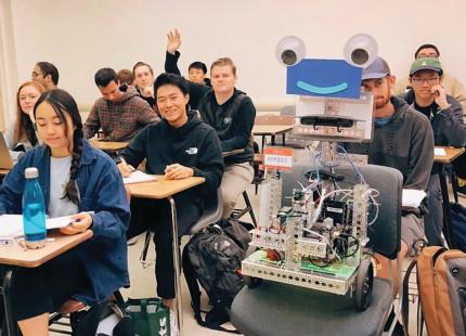 Herbie the Robot sits with students in Cal Poly classroom
