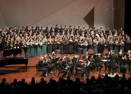 Choir and symphony perform on stage.