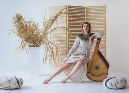 Maryna Krut poses with bandura instrument.