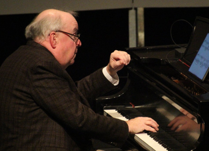 W. Terrance Spiller plays the piano.